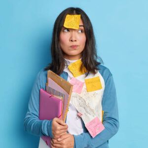thoughtful asain woman has sticky notes on clothes D9YDAKA 1